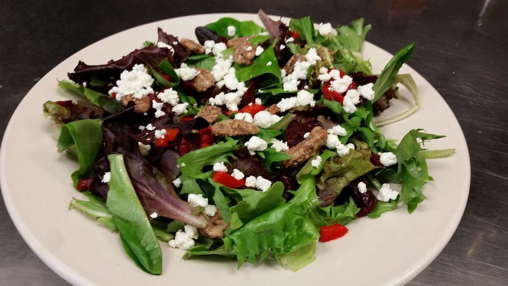 Cranberry Goat Cheese · Dried cranberries, roasted red peppers, goat cheese and candied pecans on spring greens. Served with a house-made vinaigrette on the side.