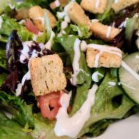 Garden Salad · Cucumbers, tomato, croutons, peppers, cheddar cheese and croutons on a bed of mixed greens s...