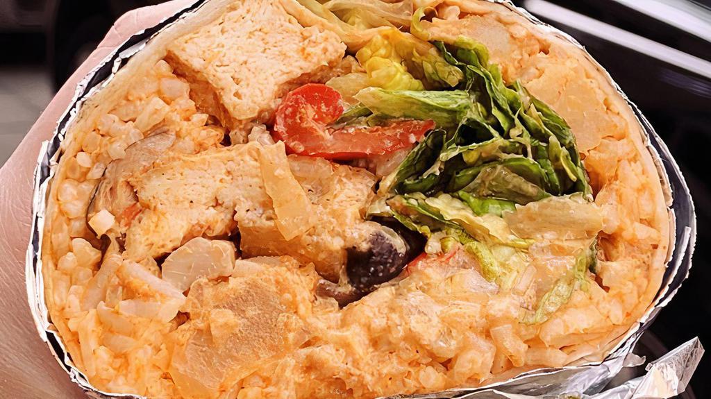 Tofu Currito · Spicy Thai curry, tofu, red bell peppers, straw mushrooms, potatoes, romaine lettuce, seasoned rice and creamy zing sauce.