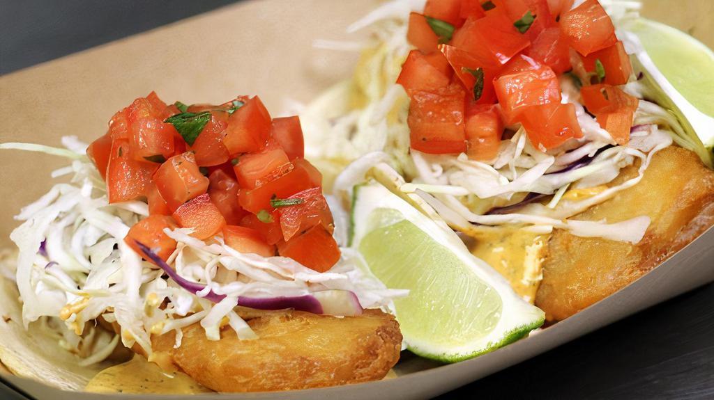Fish · Beer-battered cod, baja sauce and vinaigrette cabbage slaw topped with pico de gallo.