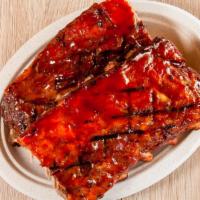 Slab · A full slab (12-13 bones) of our tender fall off the bone baby back ribs brushed with our si...