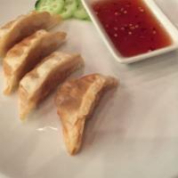 Pork Gyoza (4 Pieces) · Fried, asian pot stickers. Served with a dipping sauce.