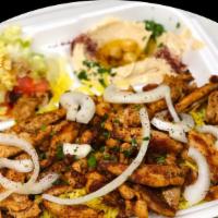 Chicken Shawarma Plate · Thin sliced chicken pieces served with rice, salad, pita bread, garlic sauce and hummus.