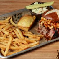 The Pretzel Bomb · This tasty sandwich features a heap of pulled pork that is covered in our macaroni and chees...