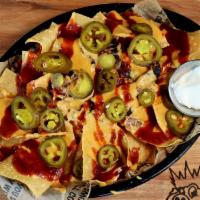 Bbq Nachos · A platter of corn tortilla chips smothered in your choice of chicken, pork, or beef brisket,...