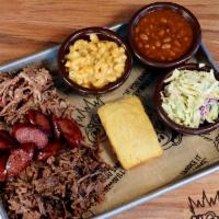 The Pig Out Platter · Three meat choices, cornbread and three sides.