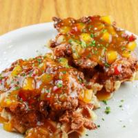 Chicken & Waffles · Hand breaded chicken tenders topped with mango habanero glaze and served over two golden Bel...