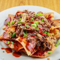 Pulled Pork Bbq Nachos · Slow roasted BBQ pork with green & red bell peppers
and onions, over tortilla chips with mel...