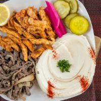 Mix Shawarma · (beef or lamb & chicken shawarma)
traditional grilled mix shredded of meat and chicken serve...