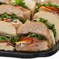 Small Classic Sub Tray · 12 - 4 inch subs, with a mixture of Ham, Turkey & Roast Beef and assorted cheeses