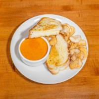 Grilled Cheese Dipper · Garlic Parmesan toast with mozzarella and Parmesan cheese. Served with tomato basil soup.