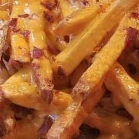 Bacon & Cheese Fries · A mountain of crisp French fries piled high with Cheddar cheese & bacon. Served with Ranch D...