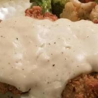 Chicken Fried Steak · Hand breaded and smothered with white gravy. Served with two sides. We proudly serve 100% US...