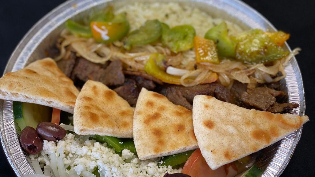 Traditional Gyro Bowl · Lamb and beef gyro slices, lettuce, tomato, onion, green pepper and feta cheese served over basmati rice with pita bread.