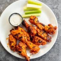 Unconventional Wings · Grilled wings, sauce, celery, ranch or blue cheese.
