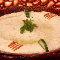 Baba Ghanouge · Smoked eggplant pureed and mixed with olive oil, lemon, juice, and garlic.