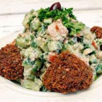 Falafel Salad · Diced cucumbers, tomatoes, falafel pieces, hummus, and mixed perfectly with tahini sauce.