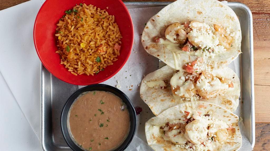 Blackened Shrimp Taco · Grilled shrimp with cotija cheese, pico de gallo and orange aioli. 3 tacos served in flour tortilla. Served with your choice of Mexican rice and re-fried beans or seasoned fries.
