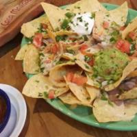 Nachos · Tortilla chips topped with re-fried beans, melted cheese, pico de gallo, jalapenos, sour cre...