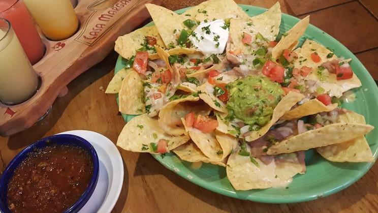 Nachos · Tortilla chips topped with re-fried beans, melted cheese, pico de gallo, jalapenos, sour cream and guacamole.