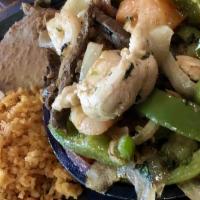 Casa'S Fajitas Combo · Grilled and served sizzling with red and green bell peppers, tomatoes and onions. With shred...
