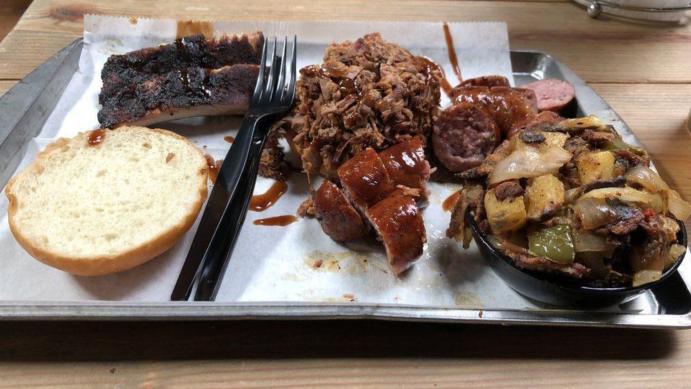 Bbq Tour · Lil Man Chopped Brisket or Pulled Pork  sandwich AND Two baby back ribs AND a Choice of: 1 Chicken Drumstick OR choice of 1 Sausage. Sandwiches come on Locally made Buns, and Tour comes with Approx 2oz BBQ sauce.