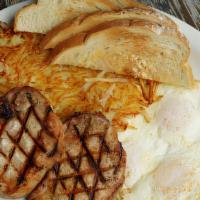 Two Pork Chops And Eggs · Two 6 OZ broiled pork chop served with two eggs, hash browns, toast, and jelly.