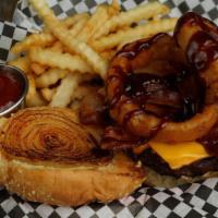 1/2 Lb. Cowboy Flame · A half pound Flameburger with melted cheese, three slices of bacon, and a slice of grilled o...
