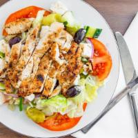 Greek Chicken Salad · Topped with a grilled chicken breast, lettuce, feta, olives, onions, tomatoes, and green pep...