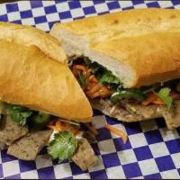Hoisin Pulled Pork · Served on a French-Vietnamese baguette with pickled carrots, cucumbers, jalapenos and cilant...