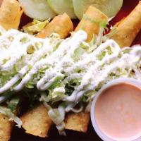 Taquitos · Four fried chicken taquitos, served with lettuce, sour cream and cotija cheese, with a side ...