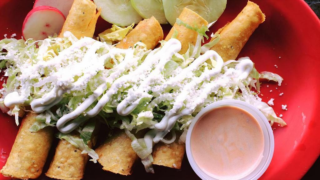 Taquitos · Four fried chicken taquitos, served with lettuce, sour cream, and cotija cheese with a side of cream salsa.