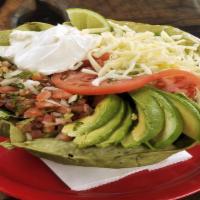 Taco Salad · Crisp spinach flour tortilla shell filled with fresh romaine lettuce, pinto beans, mozzarell...