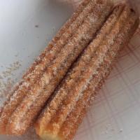 Churros · a sweet consisting of a strip of fried dough dusted with sugar and  cinnamon.