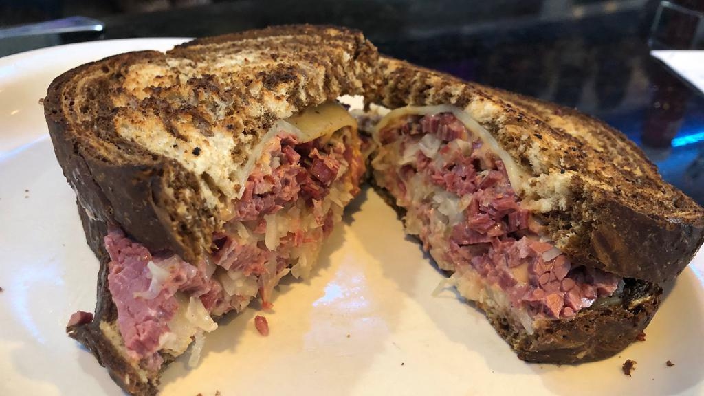 Classic Reuben · House-made thick corned beef brisket, swiss cheese, sauerkraut & 1000 island dressing served on grilled marble rye.