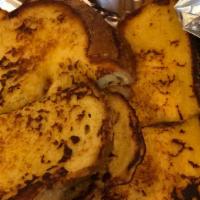 French Toast · Fresh baked challah bread dipped in our own special recipe, grilled to golden brown and ligh...
