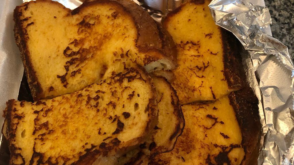 French Toast · Fresh baked challah bread dipped in our own special recipe, grilled to golden brown and lightly sprinkled with powdered sugar.