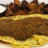 Mexican Omelette · Spicy.  Three organic eggs, filled with chorizo sausage, sweet onions, mixed cheeses and red...