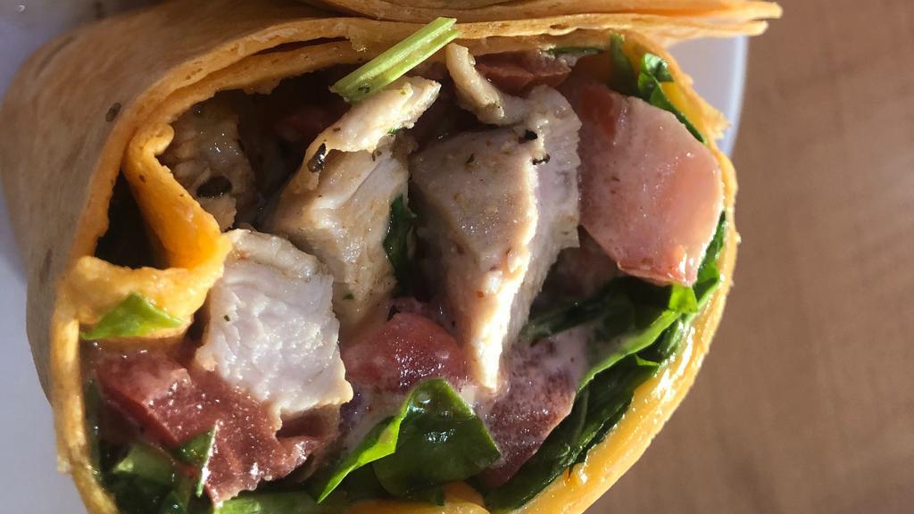 Spicy Buffalo Wrap · Leonard's choice. Grilled organic chicken breast, American cheese, buffalo sauce, spinach & tomatoes wrapped in a grilled tomato lavash.