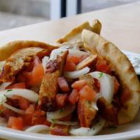 Grilled Amish Chicken Gyro · Grilled amish chicken breast, sliced sweet onions & diced tomatoes served on a grilled pita ...