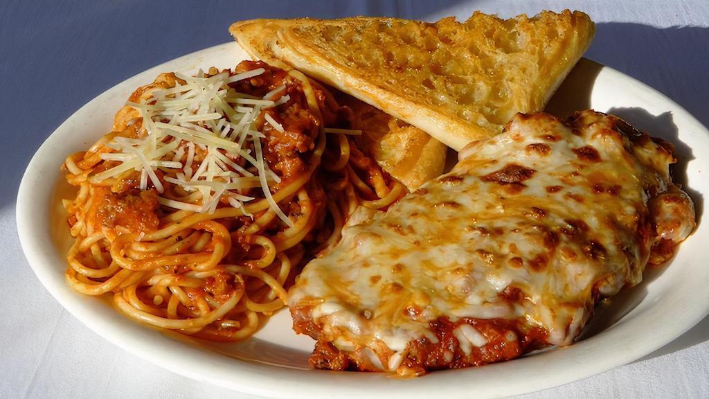 Chicken Parmesan · Breaded amish chicken breast topped with meat sauce, covered with melted parmesan & mozzarella cheese served with a side of pasta with meat sauce & garlic bread.