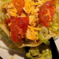 Taco Salad · Bowl shaped shell with choice of meat, topped with lettuce and cheese.