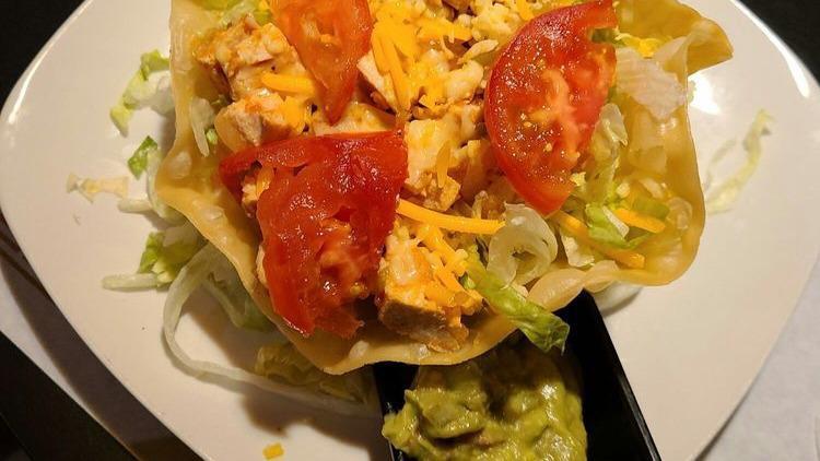 Taco Salad · Bowl shaped shell with choice of meat, topped with lettuce and cheese.