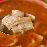 Menudo · Traditional Mexican soup made with beef tripe in broth with red chili pepper base, hominy, l...