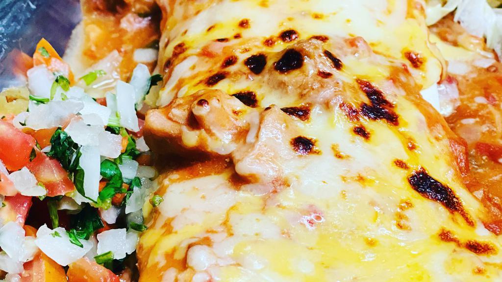 Pancho Villa · Jumbo flour tortilla stuffed with beans, chile verde pork, and ground beef, topped with chile verde and melted cheese, served with pico de gallo and lettuce on the side.