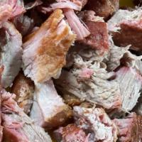 Carnitas · Lean pork marinated with oranges and spices, then slowly cooked until tender. Served with be...