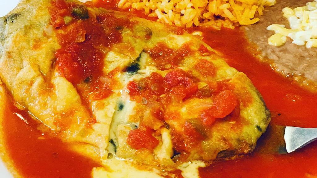 Chile Relleno · Poblano pepper stuffed with cheese, butter dipped, and deep fried, served with beans, rice, guacamole, and tortillas. Add beef or chicken for an additional charge.