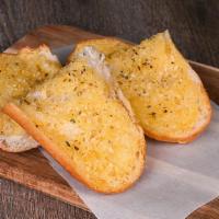 Garlic Bread · An Italian loaf halved topped with garlic butter, sprinkled with Parmesan cheese and herbs f...