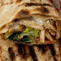 Chicken Shawarma Sandwich · Chicken Shawarma with tomatoes, lettuce, pickles, spread with a garlic sauce and topped with...