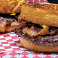 Texas Mr. Big Bbq Burger · Double Decker Burger, BBQ sauce, bacon, onion ring, american cheese on a garlic Texas toast.